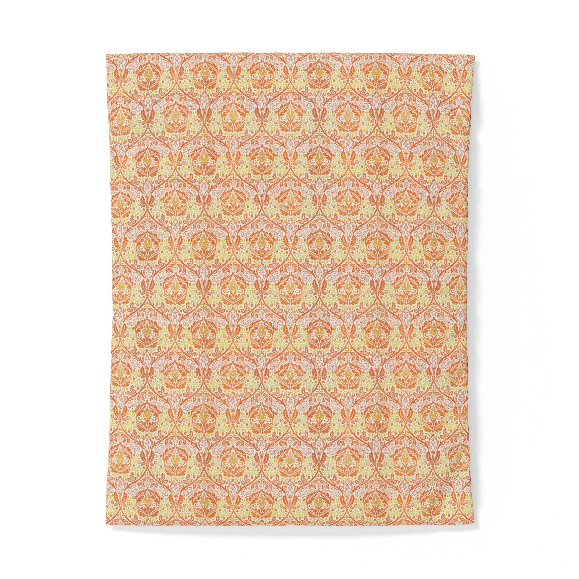 A rectangular textile item, likely a towel or blanket, featuring a repeating ornate damask-style pattern in warm orange, peach, and pale yellow tones on a light background.