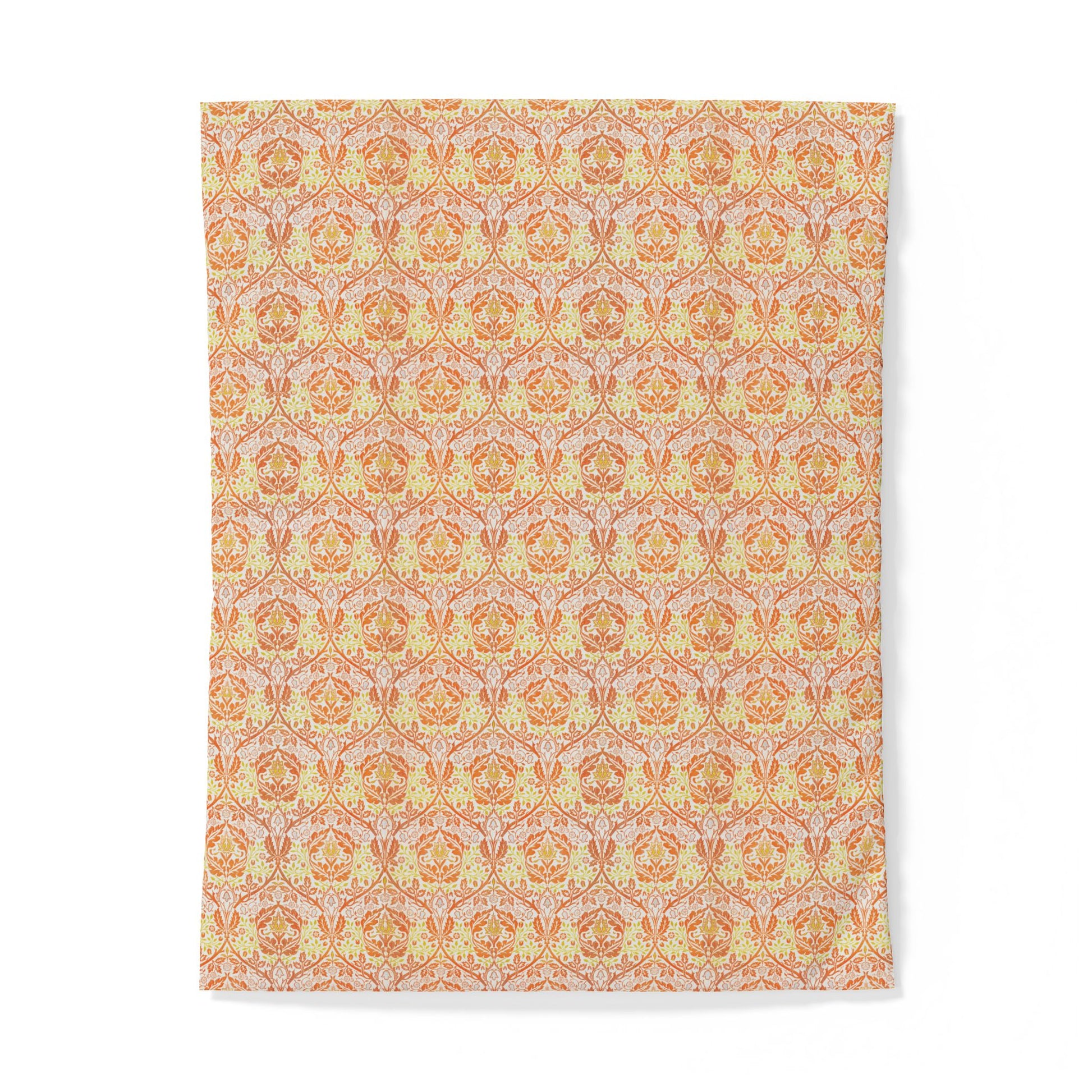 A rectangular fabric item, likely a towel or blanket, featuring an intricate repeating damask pattern in warm tones of orange, yellow, and soft pink on a light beige background.