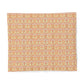 A square fabric placemat featuring a repeating ornate damask pattern in warm peach, orange, and pale yellow tones on a light pinkish-beige background, shown flat against a white background.