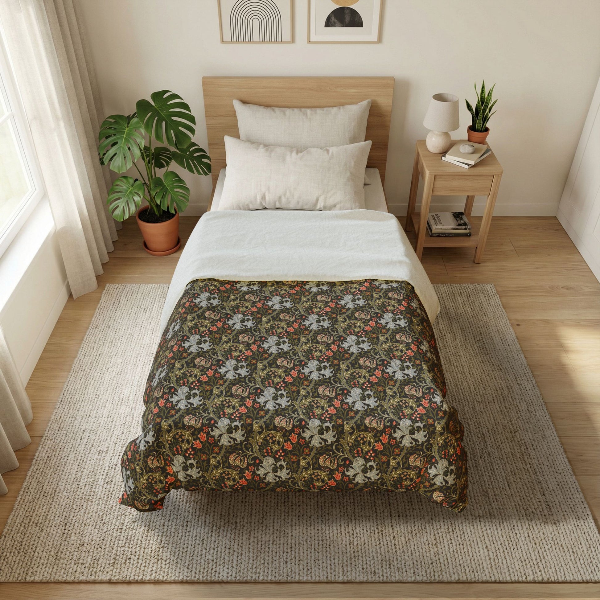 A neatly made bed in a bright, modern bedroom. The bedding set features a dark brown floral patterned comforter with white and orange accents, layered over white sheets and pillows, on a light wood bed frame.