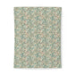 A rectangular textile item, likely a towel or blanket, featuring an intricate vintage-style floral and botanical pattern in muted teal, sage green, beige, and soft rust red on a light cream background.