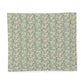 A square fabric or paper sample with an all-over floral pattern in muted teal, beige, cream, and soft rust tones, shown flat against a white background.