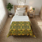 Bedroom with a bed featuring a green and yellow patterned comforter.