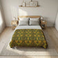 Bedroom with floral-patterned comforter on a bed, wooden nightstands, and framed pictures on the wall.