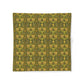 Patterned fabric swatch with green and yellow design on a white background