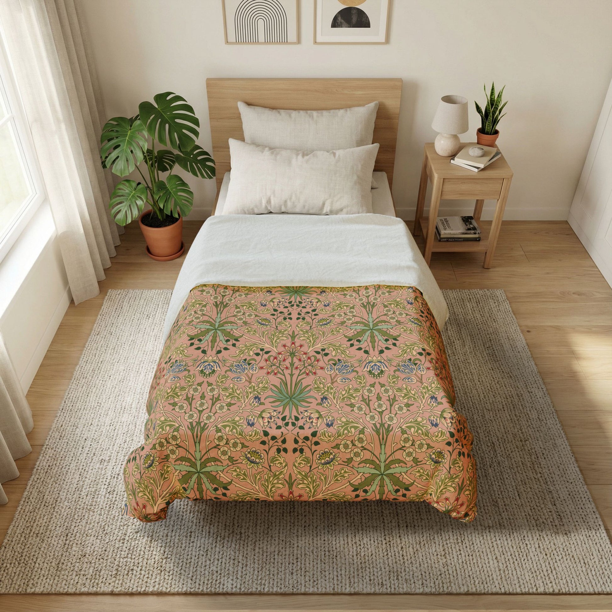 Bedroom with a bed featuring a floral-patterned comforter, side table with lamp and books, and plants.