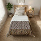 Bedroom with floral comforter, nightstand, and plants