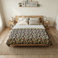Bedroom with floral-patterned bedspread on a wooden bed