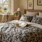 Cozy bedroom with floral bedding, a book, and a mug on a bed.