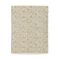A rectangular fabric item, likely a tea towel or hand towel, featuring a dense all-over floral and botanical pattern in soft beige, cream, muted orange, and light blue tones, shown against a plain white background.