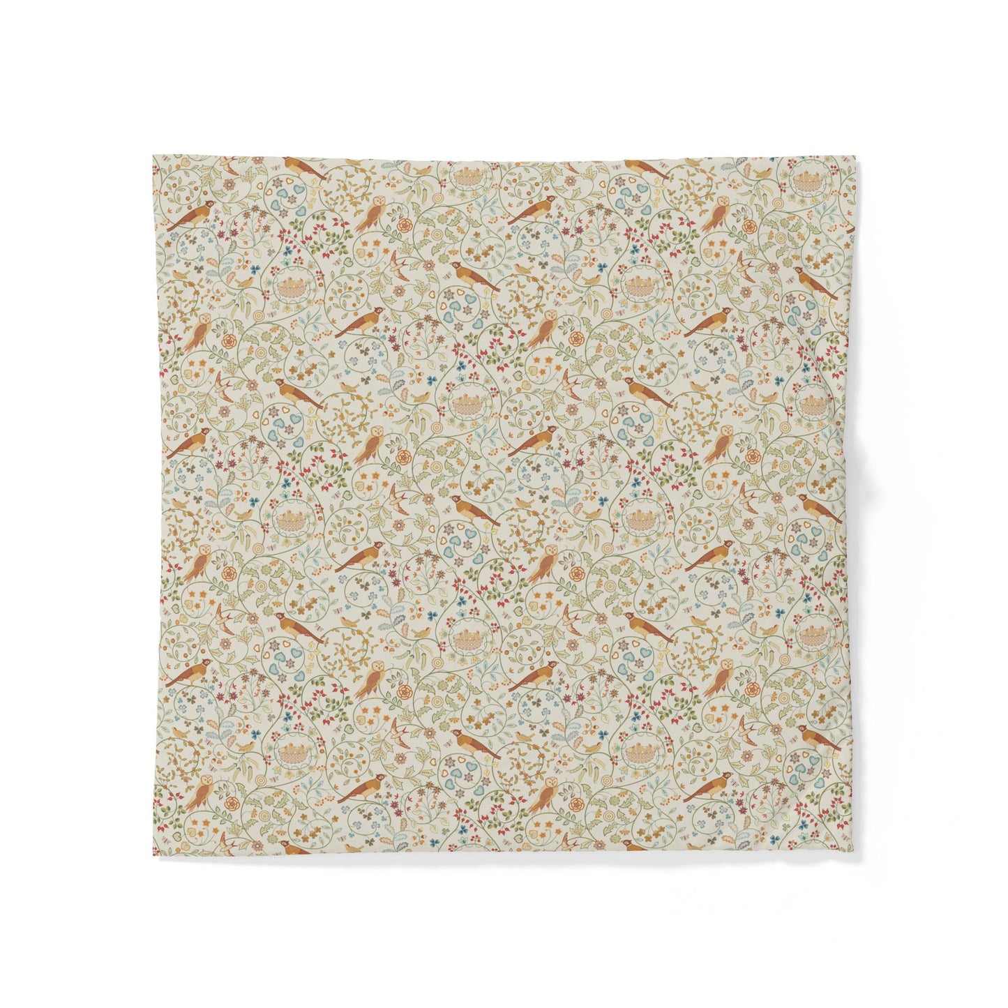 A square fabric napkin or small table linen featuring a dense vintage-style floral and bird pattern on a warm cream background, displayed flat against a white background.