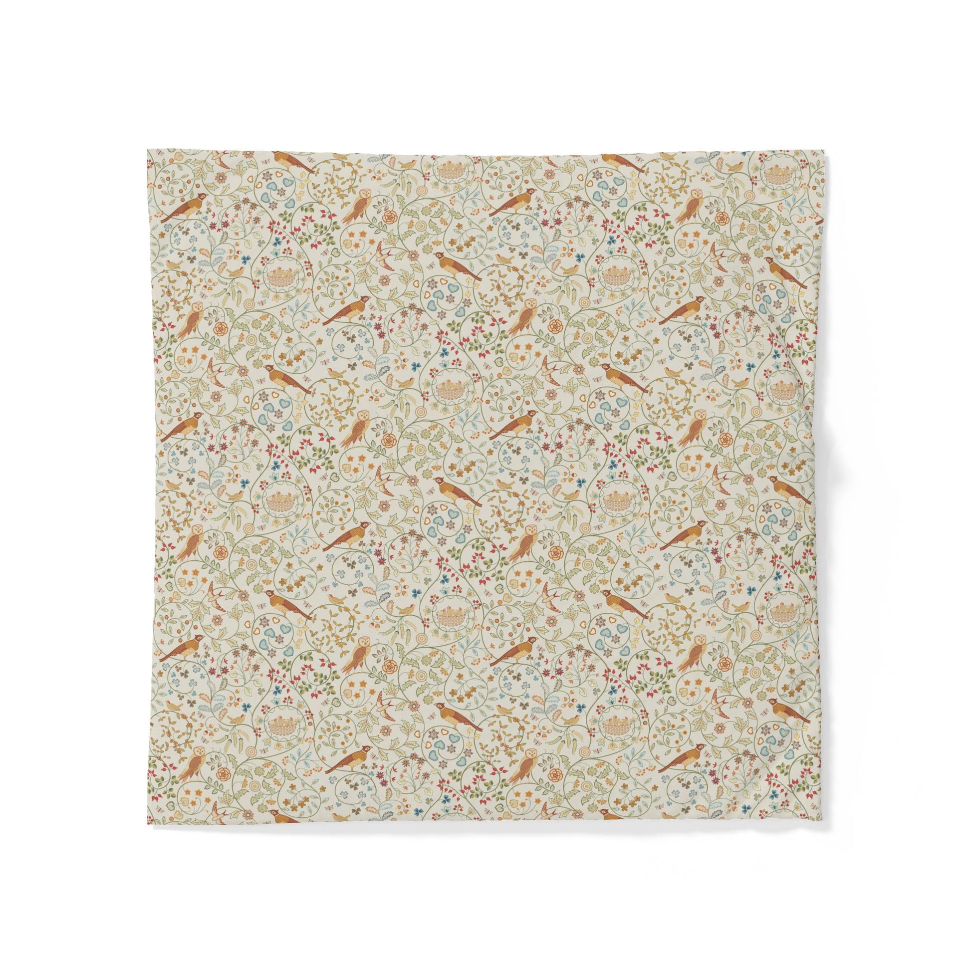 A square fabric napkin or small table linen featuring a dense vintage-style floral and bird pattern on a warm cream background, displayed flat against a white background.