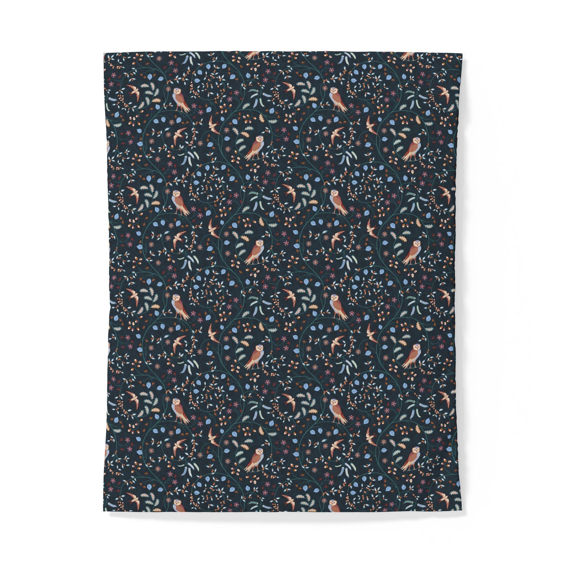 A rectangular fabric item, likely a blanket or throw, featuring a dense all-over print of small birds, leaves, and dots on a dark navy background, shown against a plain white background.