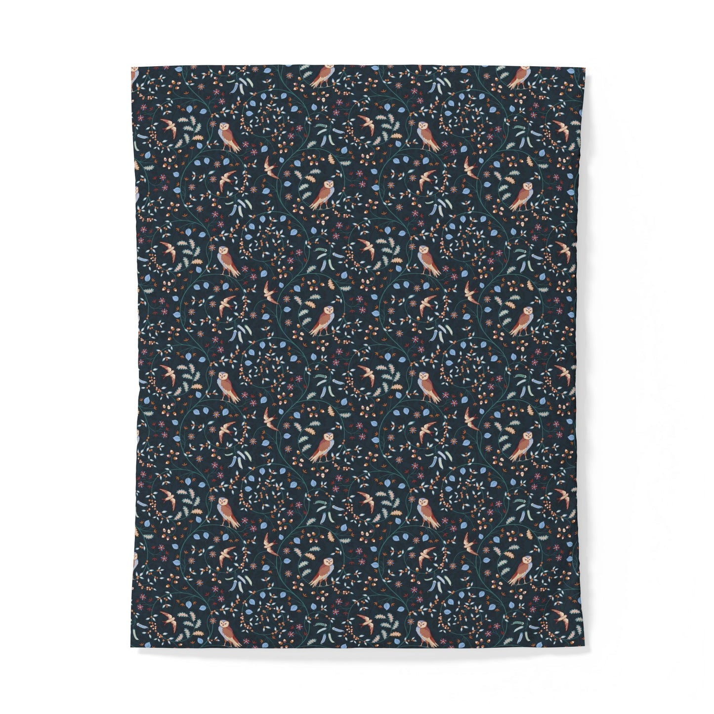 A rectangular fabric item, likely a blanket or tapestry, featuring a dense botanical and bird pattern on a dark navy background. The pattern includes small peach-colored birds, light blue flowers, and green leaves.
