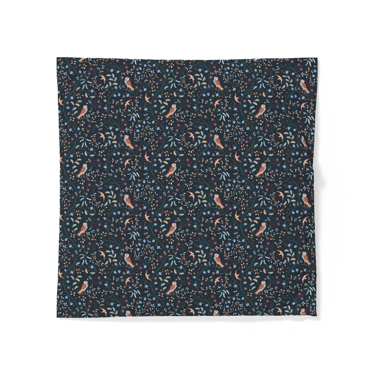 A square fabric item, likely a napkin or small tablecloth, featuring a dense all-over pattern of small birds, leaves, and berries on a dark navy blue background. The birds are a muted peach-pink color, while the foliage and berries are in shades of blue and green.