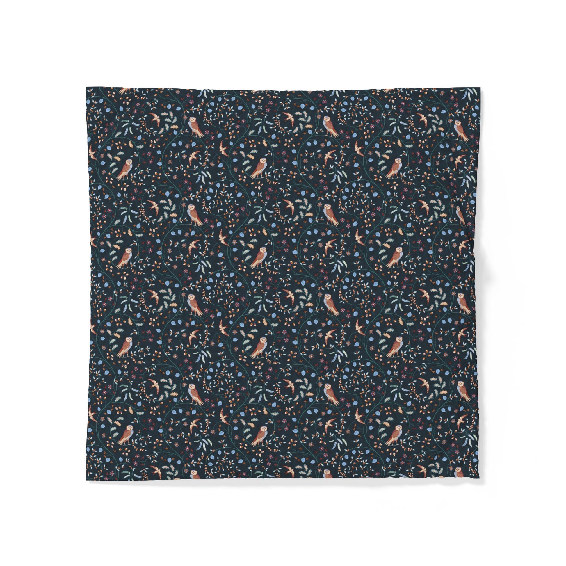 A square fabric item, likely a napkin or small tablecloth, featuring a dense all-over pattern of small birds, leaves, and berries on a dark navy blue background. The birds are a muted peach-pink color, while the foliage and berries are in shades of blue and green.