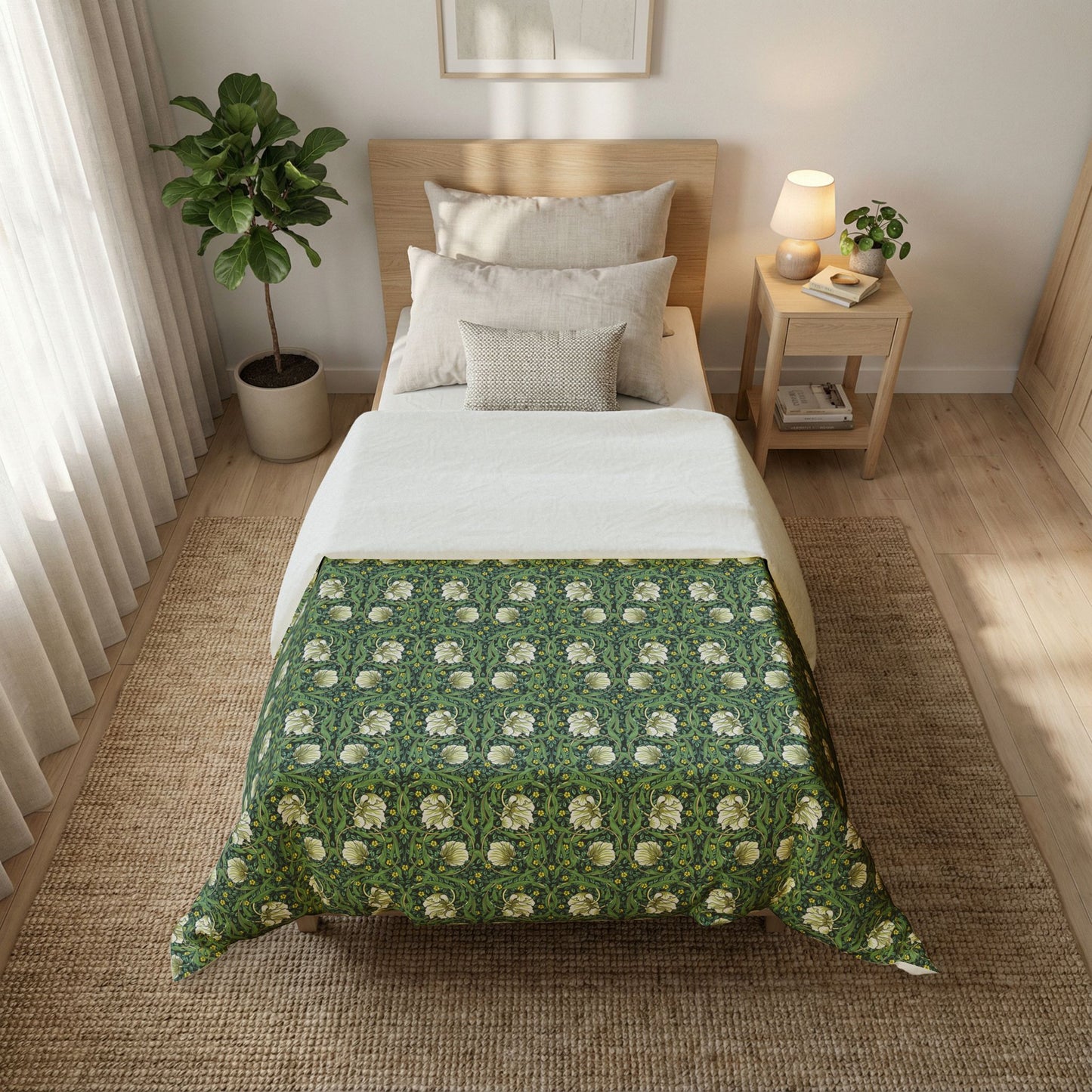 Bedroom with a bed covered by a floral-patterned comforter, nightstand, and plant.