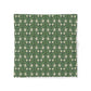 Green fabric with white floral pattern on a white background