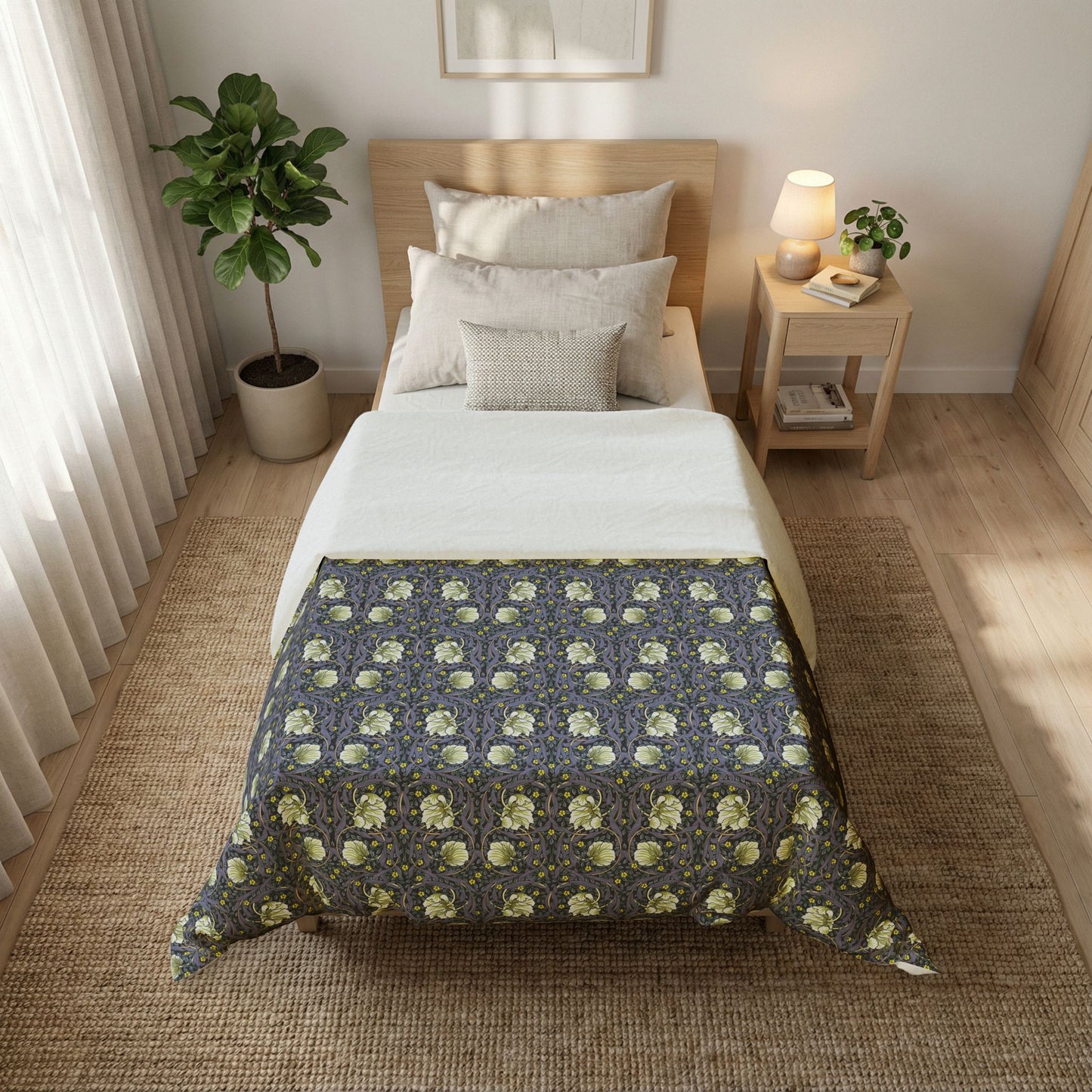 Bedroom with a bed covered by a floral-patterned comforter, nightstand, and plant.