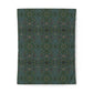 A rectangular textile or fabric sample with an intricate repeating ornamental pattern in dark teal, green, blue, and muted pink, shown flat against a white background.