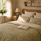 Cozy bedroom with floral bedding, wooden headboard, and decorative elements.