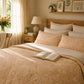 Cozy bedroom with floral bedding, open book, and decorative elements.
