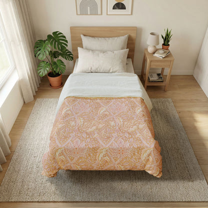 Bedroom with a bed featuring a patterned duvet, nightstand with lamp, and plants.