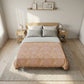 Bedroom with a bed featuring a patterned duvet cover, light wood headboard, and nightstands.