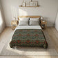 Bedroom with floral-patterned comforter on a bed, wooden nightstands, and framed pictures on the wall.