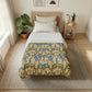 Bedroom with floral comforter, plants, and a side table.