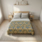 Bedroom with floral-patterned comforter on a bed, wooden nightstands, and framed pictures on the wall.