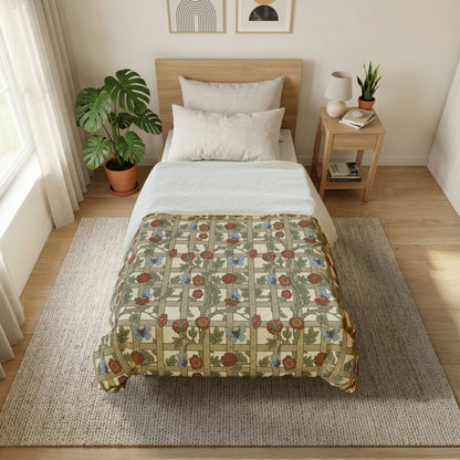 Bedroom with floral-patterned comforter on a bed, side table with lamp and books, and plants.