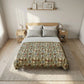 Bedroom with a bed featuring a floral patterned comforter, two nightstands, and framed pictures on the wall.