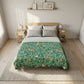 Bed with floral patterned comforter in a bedroom setting