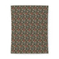 Floral patterned fabric swatch with foxes on a green background