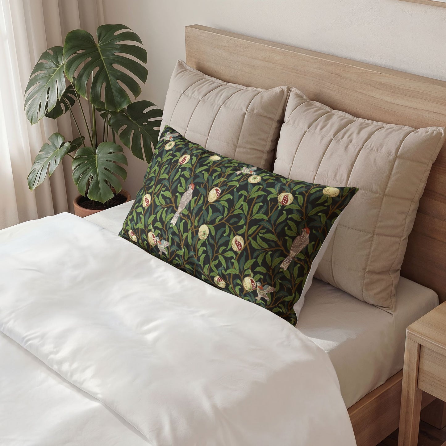Decorative pillow with bird pattern on a bed in a bedroom setting