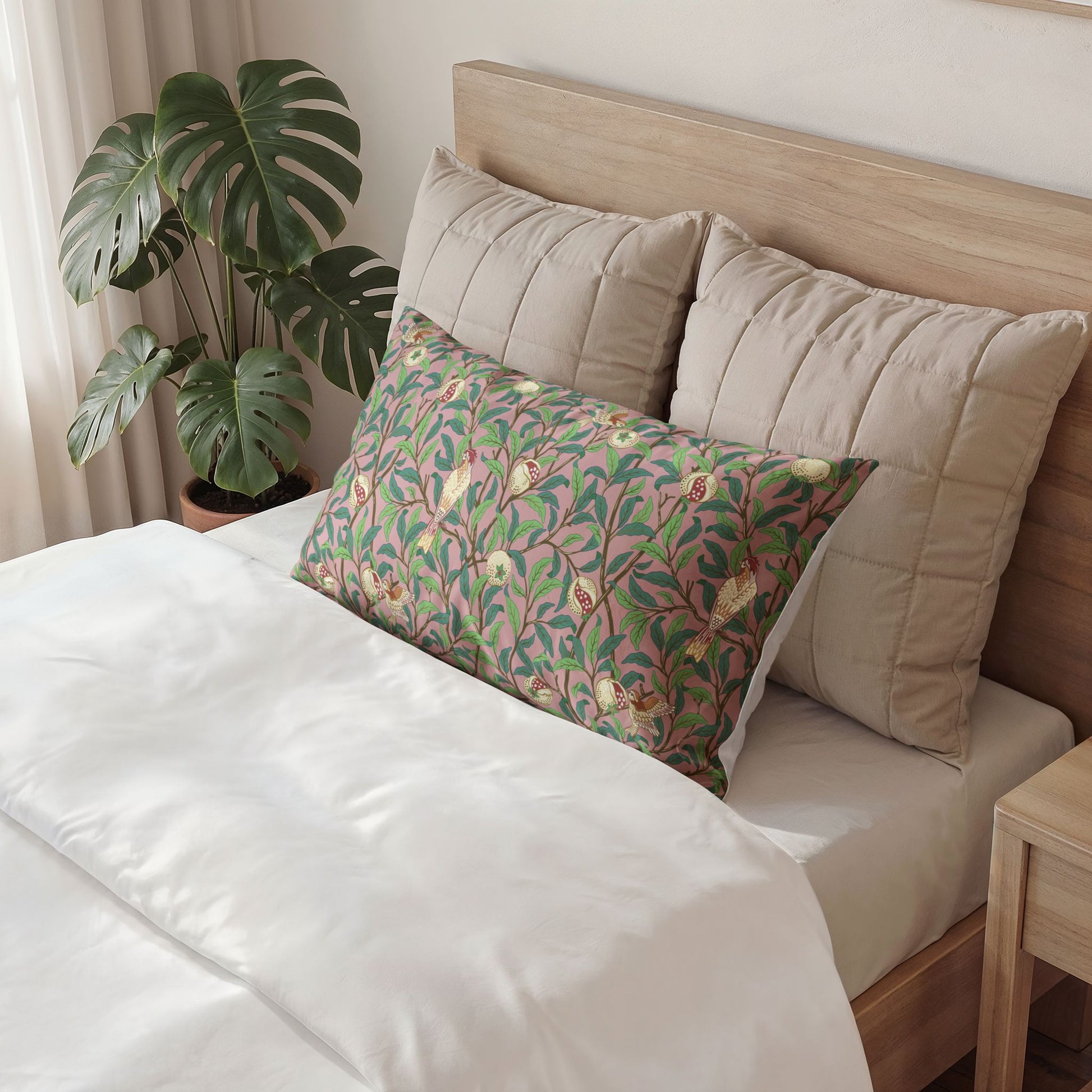 Bed with decorative pillows and a plant in the background