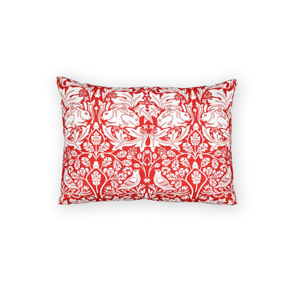 Red pillow with white floral pattern on a white background