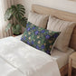 Neatly made bed with decorative pillows and a plant in the background