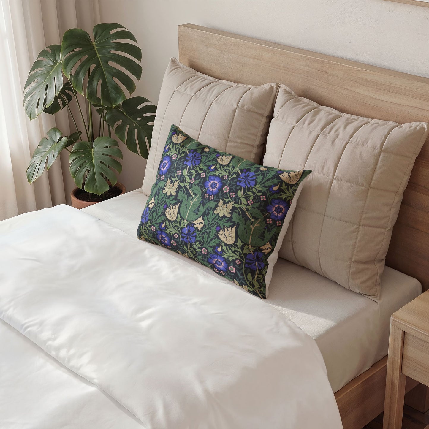 Gray pillow with a design on a bed in a bedroom setting