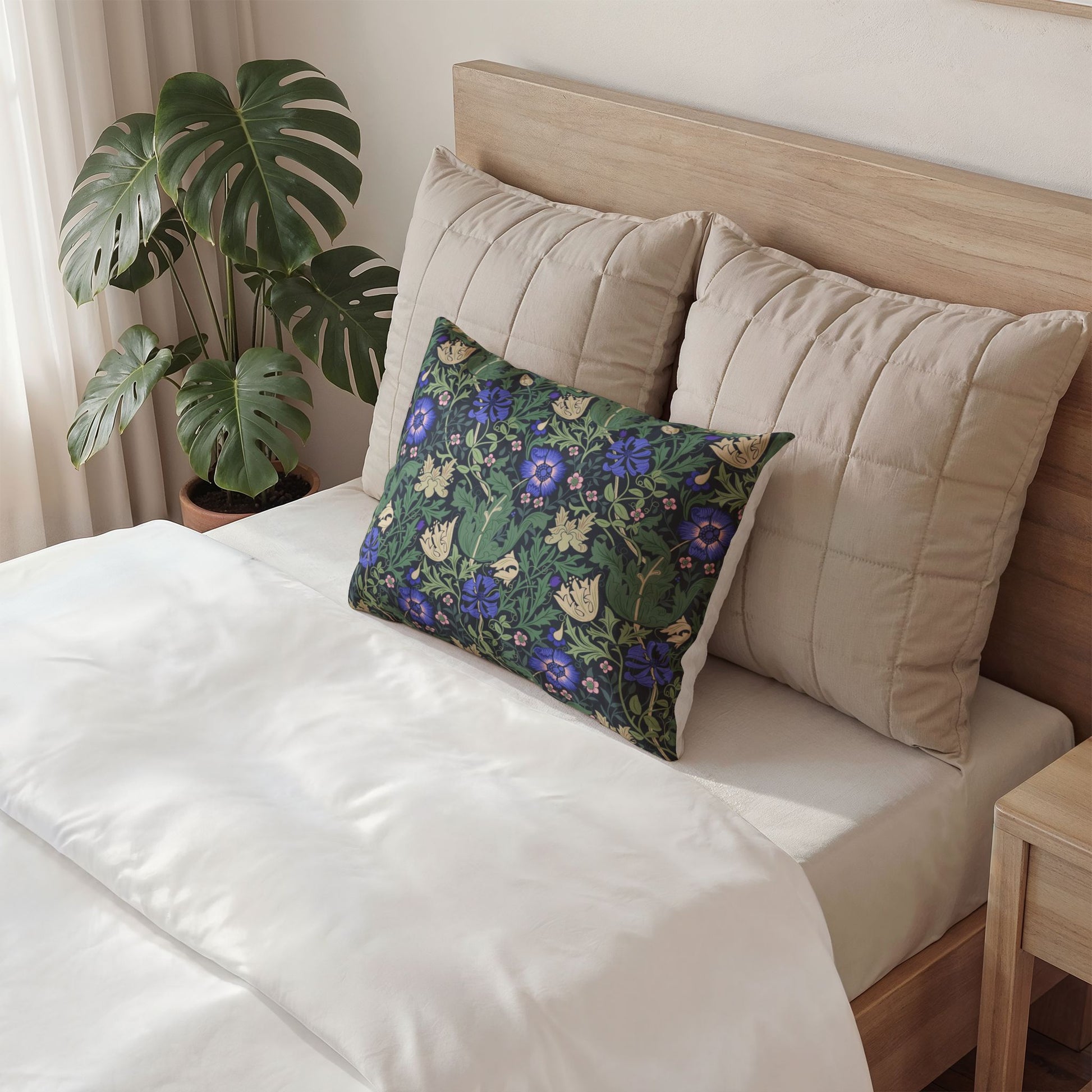 Gray pillow with a design on a bed in a bedroom setting