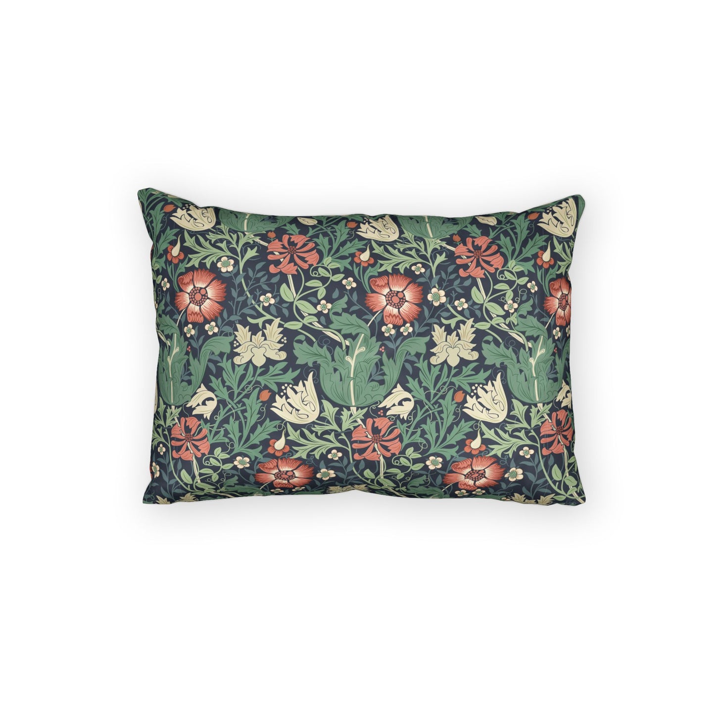 A rectangular decorative throw pillow featuring a dense floral and botanical pattern with red flowers, green leaves, and cream blossoms on a dark navy background, shown against a plain white studio backdrop.