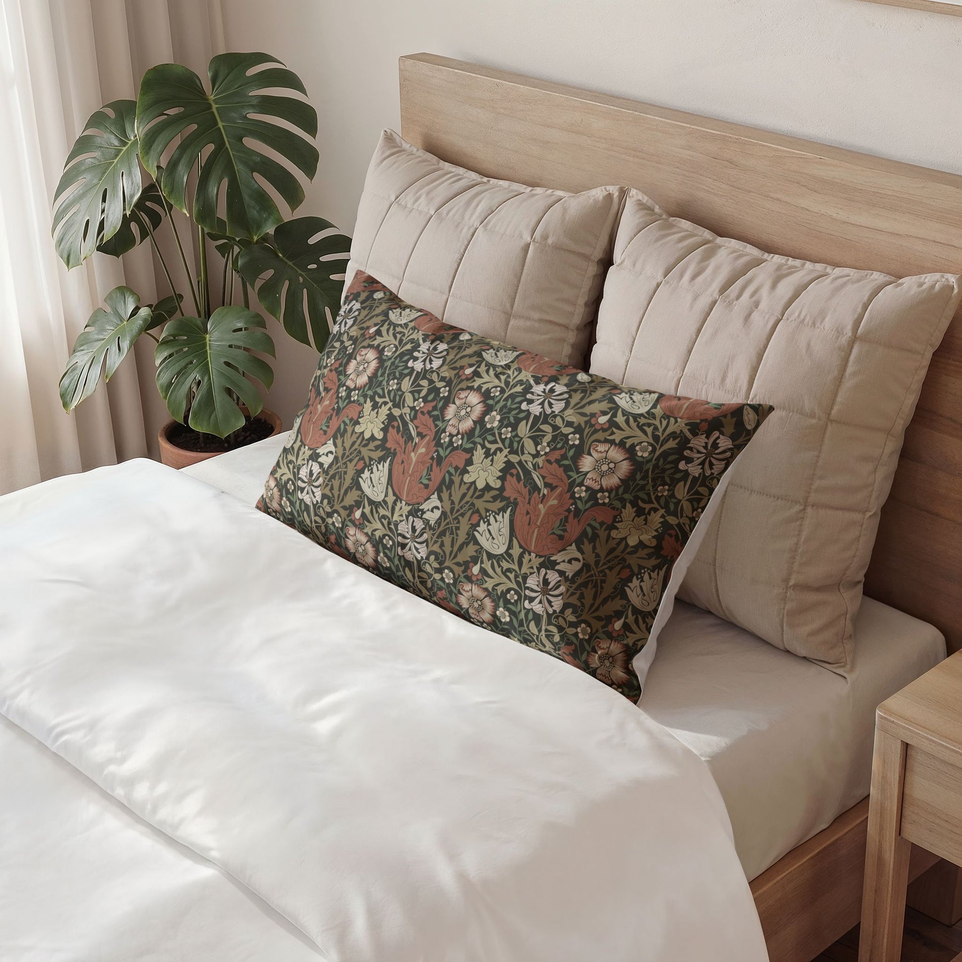 Bed with beige pillows and a purple accent pillow, next to a plant in a room.