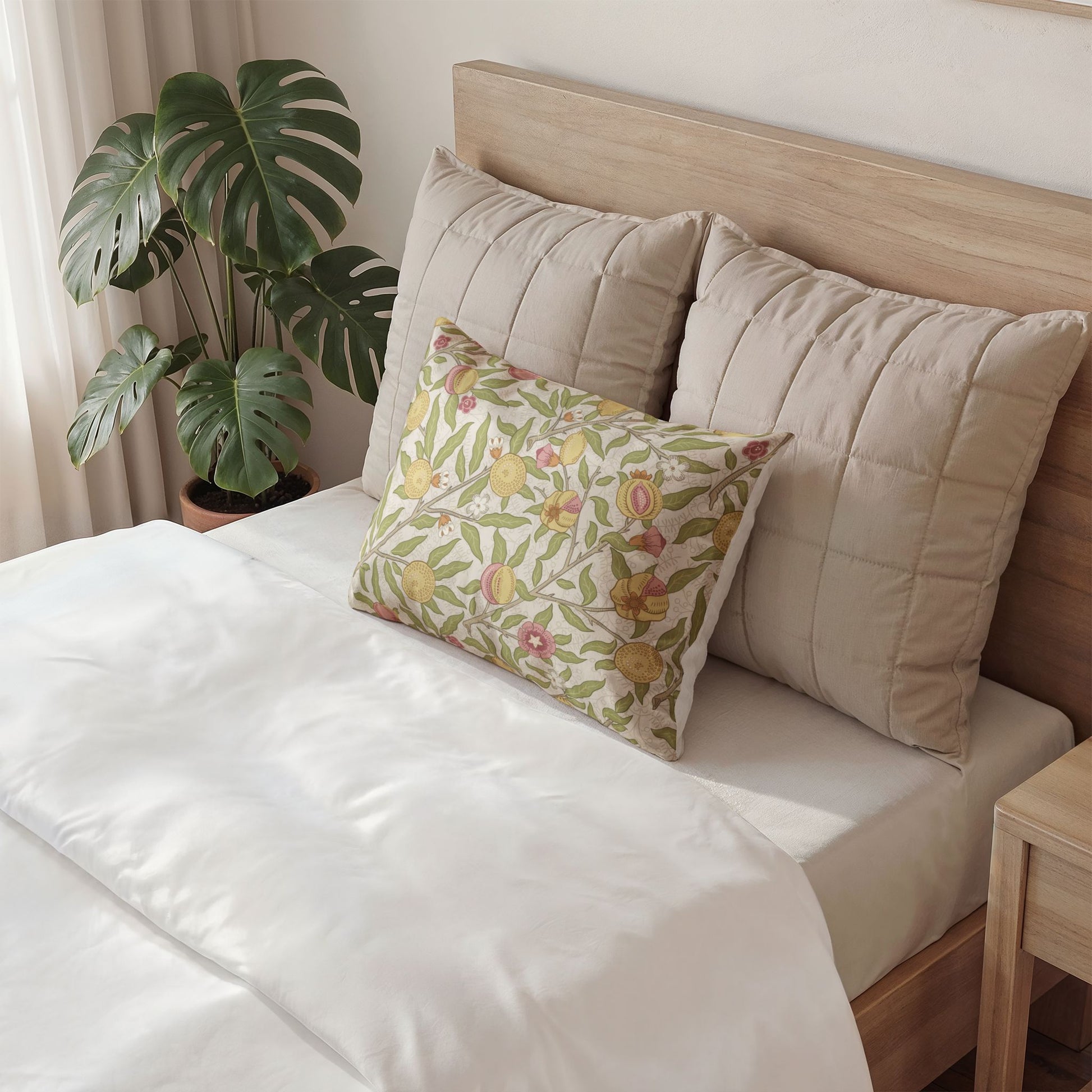 Decorative pillow with floral pattern on a bed in a bedroom setting
