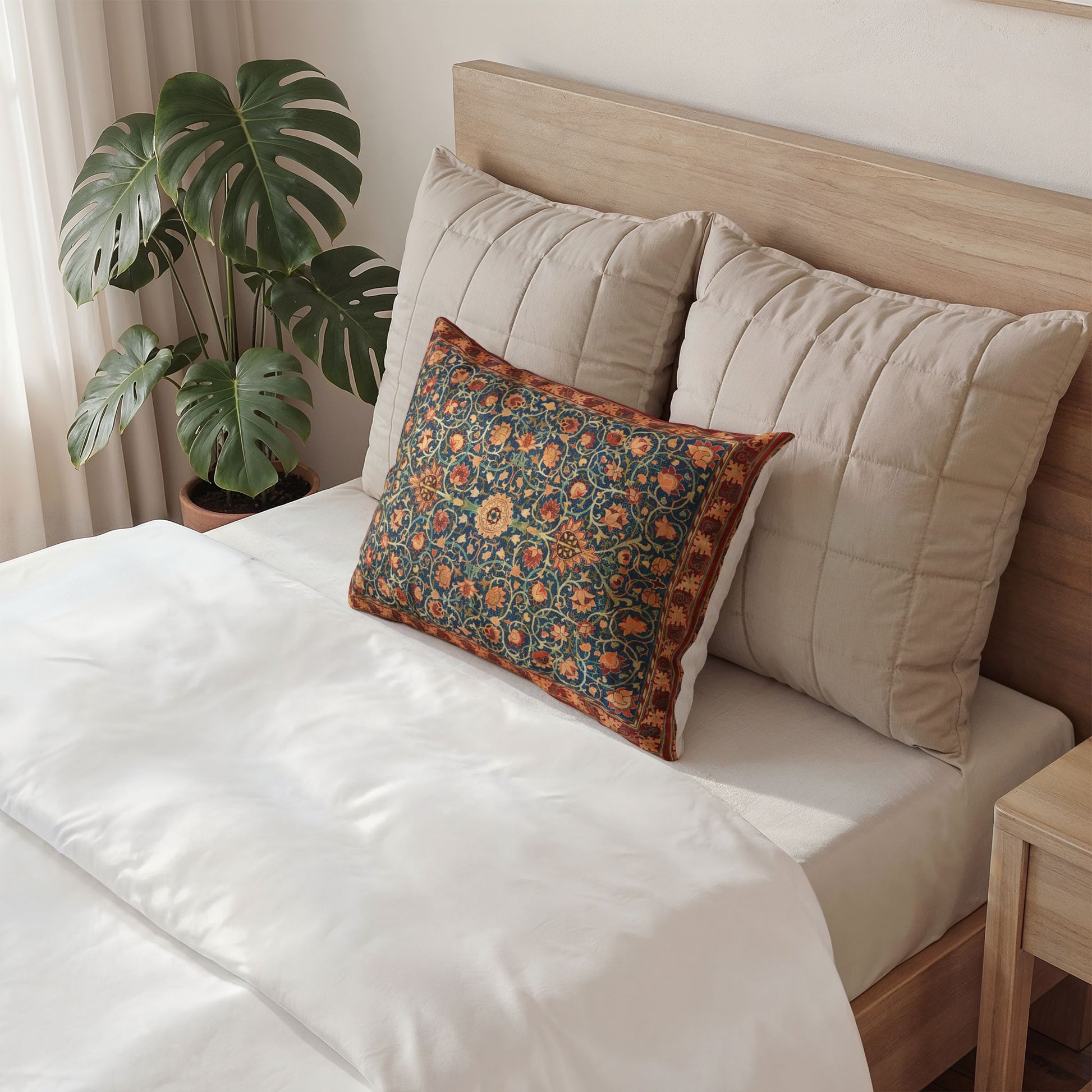 Neatly made bed with decorative pillows and a plant in the background