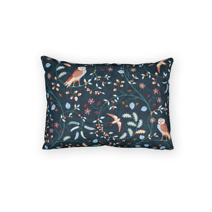 A rectangular throw pillow featuring a dark navy blue background with a detailed botanical and avian pattern of owls, birds, flowers, and leaves in muted orange, beige, and light blue tones, shown against a plain white background.