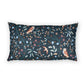 A rectangular throw pillow featuring a dark navy blue background with a detailed botanical and avian pattern of birds, flowers, and leaves in muted teal, brown, and light blue tones.