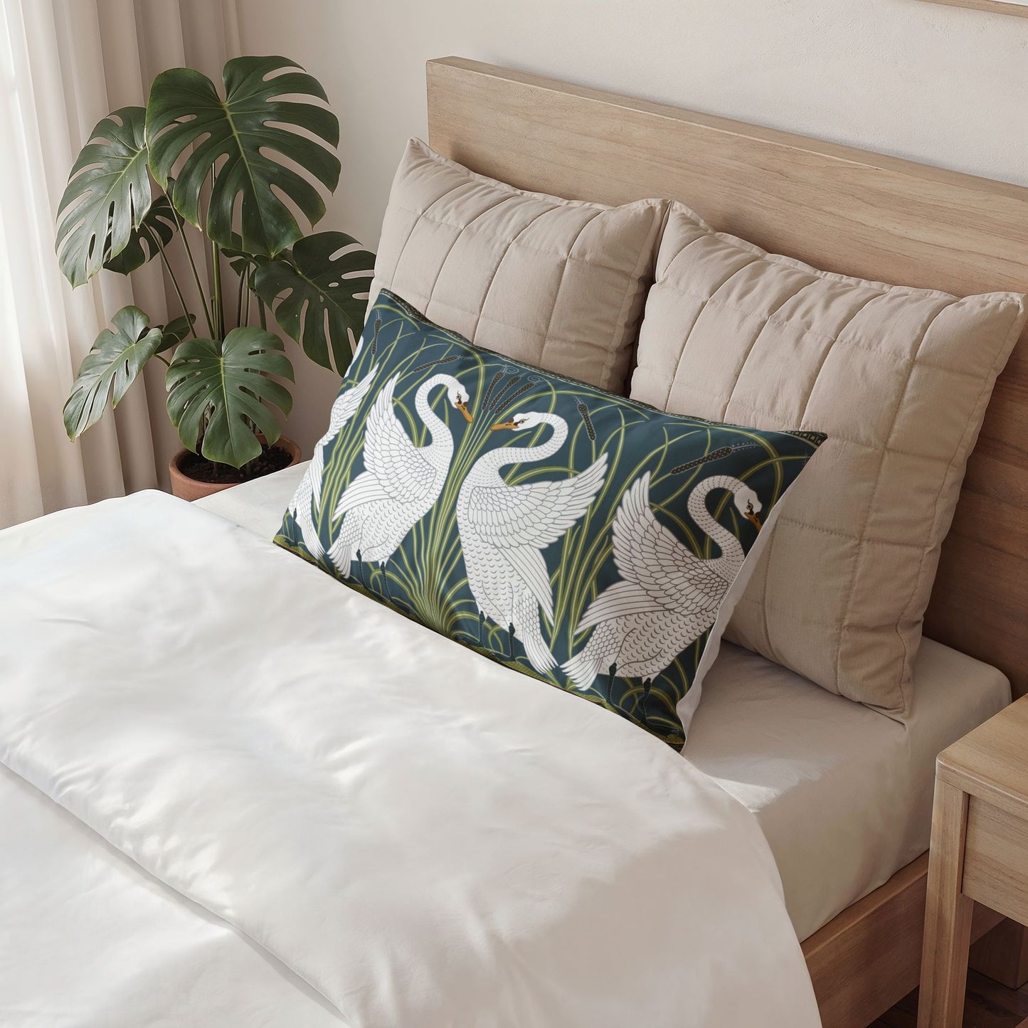 Decorative pillow with swan design on a bed in a bedroom setting