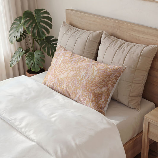 Bed with decorative pillows and a plant in a room setting