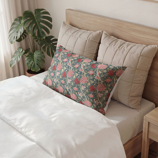 Bed with decorative pillows and a plant in the background